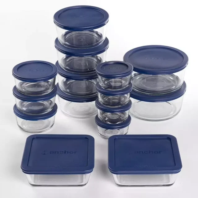 Premium Glass Food Storage Set with Navy Lids neatly arranged on a kitchen counter, showcasing 30 versatile containers in various shapes and sizes.